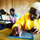 A man taking a literacy class in Burkina Faso