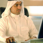 An Arab man using a computer