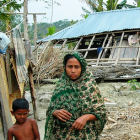 A woman and a child in front of a destroyed house in Bangladesh