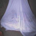 Pregnant woman and child under an insecticide-treated bednet