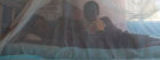 Child under bednet by Flickr/ Gates Foundation