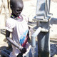 A child drawing water at a well in South Sudan