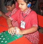 A child at the Mathru school using the Braille tutor