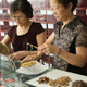 Women weighing Chinese medicine