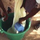 Bednets being dipped in insecticide