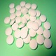 Round, biconvex white tablets