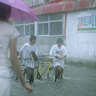 Boys wading through a flood