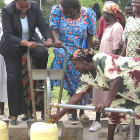 Women operating foot water pump in Kenya