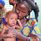 A woman and child receive humanitarian assistance in the Sahel A woman and child receive humanitarian assistance in the Sahel
