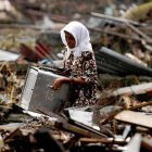 Woman searches through wreckage in the aftermath of Indian Ocean tsunami