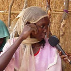 A journalist interviewing a woman in Africa