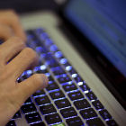 A man typing on a laptop