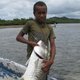 Local Kubulau youth with a giant trevally