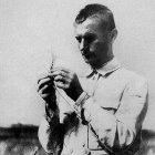 Lysenko studying wheat in the field