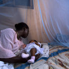 Mother and child under malaria bednet, Ghana Mother and child under malaria bednet, Ghana