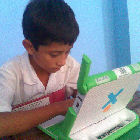 Child using OLPC laptop