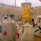 Workers monitoring radioactive waste tank
