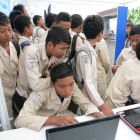 Schoolchildren around laptops, Indonesia Schoolchildren around laptops, Indonesia