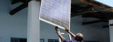 Men with a solar panel in Tanzania - Flickr/PRI's The World