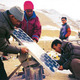 Men setting up solar panels in rural village