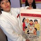  A healthworker shows a TB educational chart, Peru