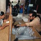 Sputum collection cups being distributed at a TB clinic in Dhaka, Bangladesh