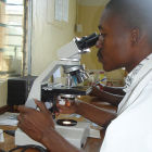 African lab worker analysing a sputum sample