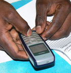 A pair of hands texting on a mobile