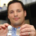 Eric Hoek holding the engineered nanoparticles and a piece of the membrane