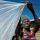 A woman airs out a bednet