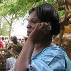 A woman using a mobile phone in rural Africa