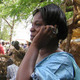 A woman using a mobile phone in rural Africa