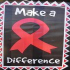AIDS poster close-up red ribbon and slogan 'make a difference'