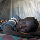 African child sleeps under bednet