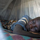 Child sleeping under bed net