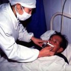 Nurse tending to TB patient in China