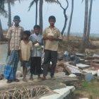 Sri Lankan tsunami eyewitnesses on remains of a house destroyed by the waves