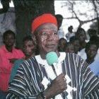 Ghanian elder leading a community debate about a new drug to treat schistosomiasis.