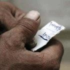 An Iraqi holding the name of a victim on a scrap of paper: those who escape the death threats face a different set of challenges in the West