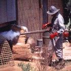 A health worker in Thailand sprays insecticide to control malaria 
