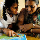 Indian girl and her mother look at a map
