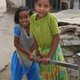 Indian children pumping water
