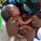 Infant being immunised
