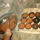 Jaggery production - pouring the boiled treacle into coconut shells to produce the hardened solid form of it