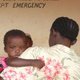 Mother signing baby into hospital in Kenya