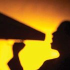 shadow of someone speaking into loudspeaker.