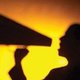 shadow of someone speaking into loudspeaker.