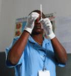 A nurse prepares an injection of anti-malaria vaccine