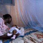Mother and baby under bednet