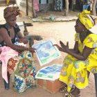 Community health worker selling USAID-subsidised bednets in Senegal